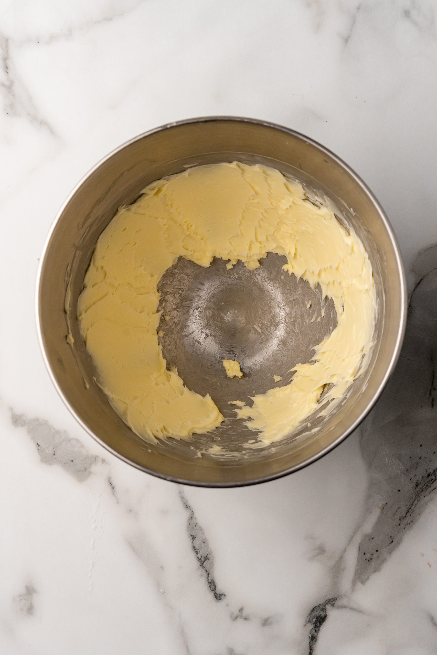 creamed butter in a metal mixing bowl