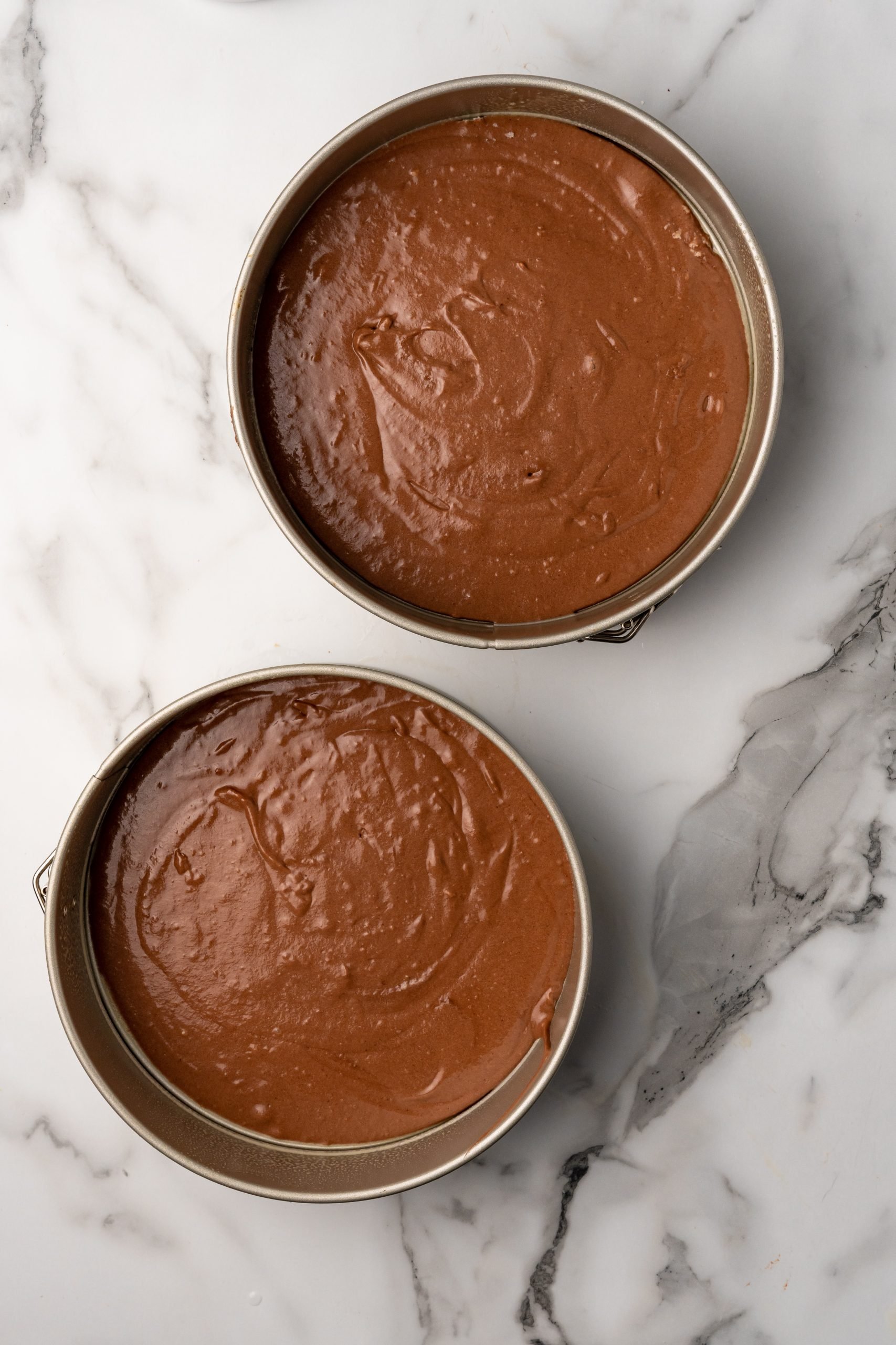 chocolate cake batter in two 9 inch round cake pans