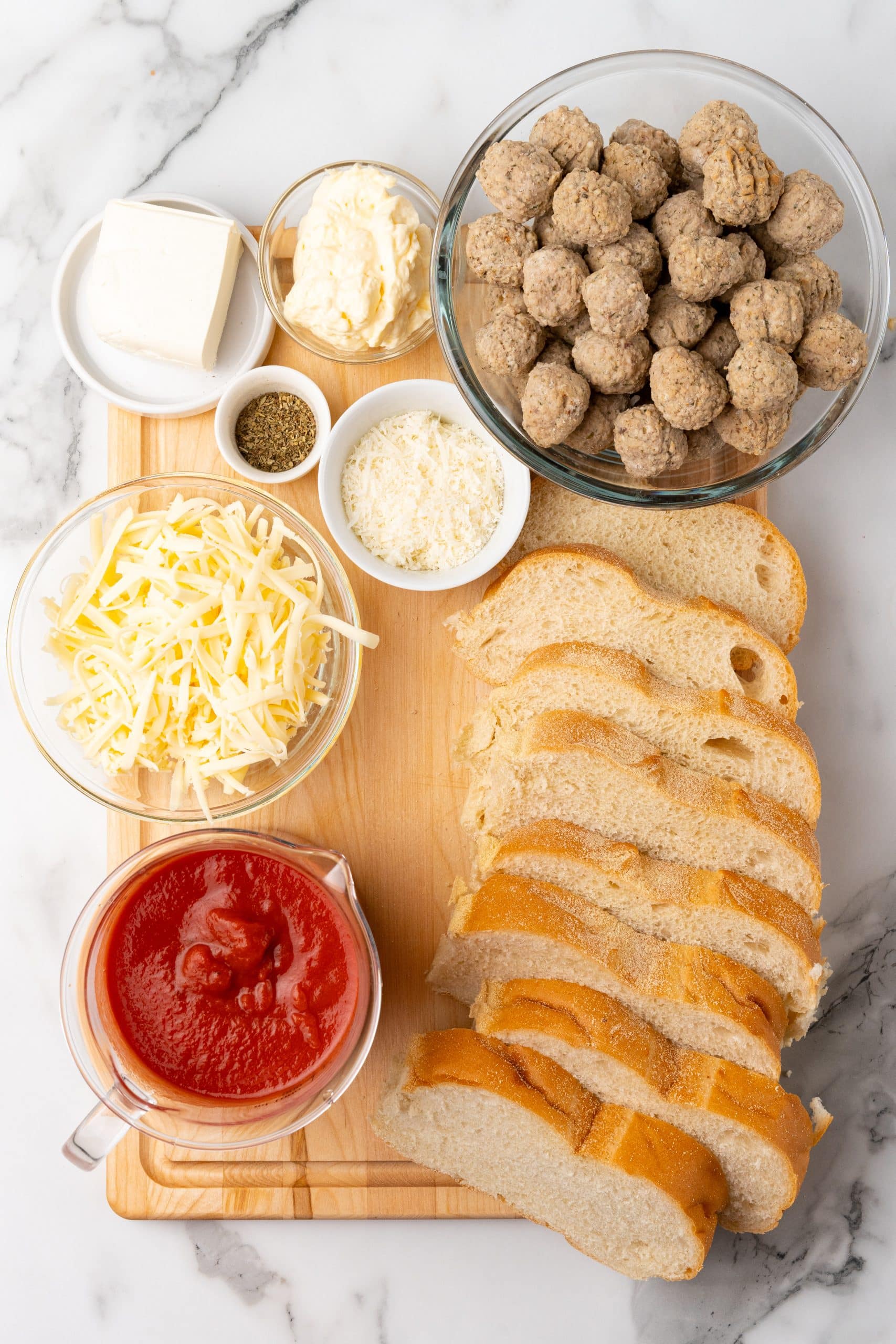 an overhead image showing the measured ingredients needed to make a meatball sub casserole