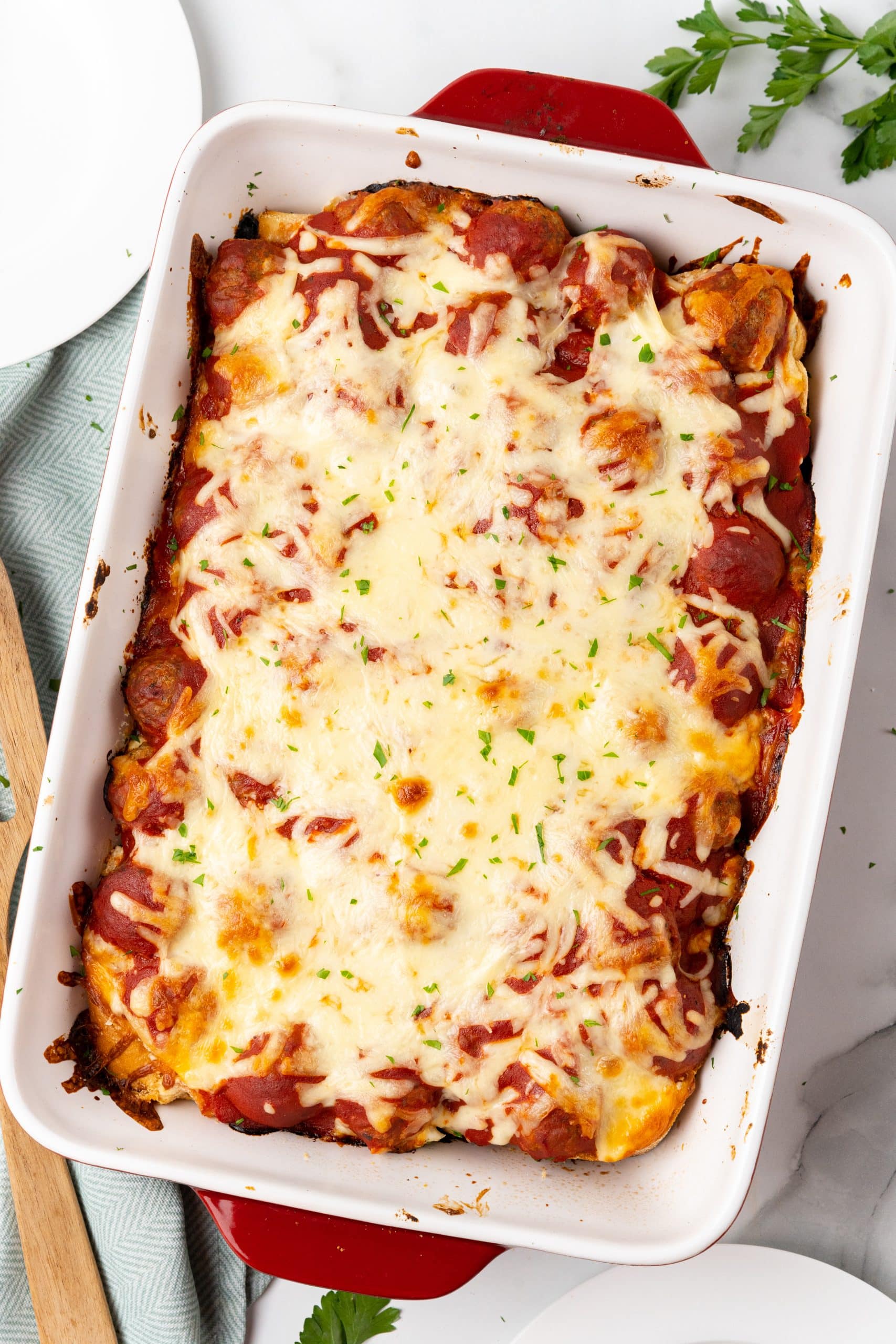 baked meatball sub casserole in a large white baking dish