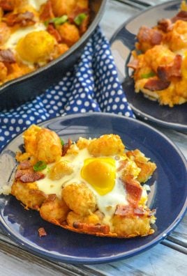 BACON EGG AND CHEESE BREAKFAST TOTCHOS ON A SMALL BLUE PLATE