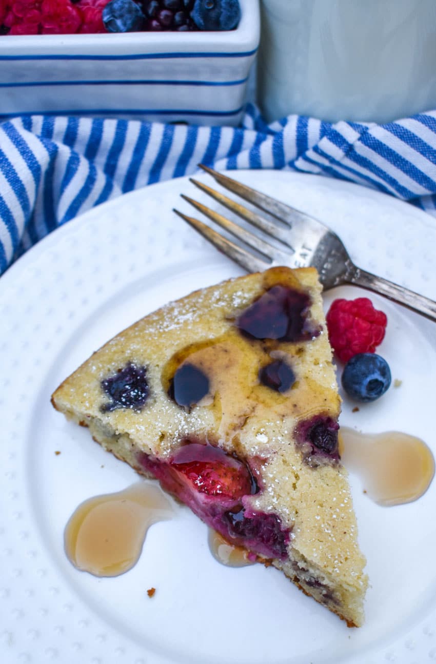 a sliced of homemade cast iron pancake on a white plate