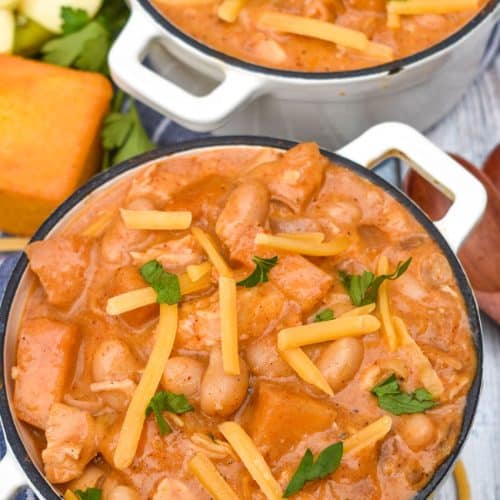 white cheddar apple chicken chili in two small white soup bowls