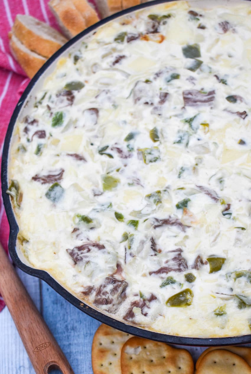 philly cheesesteak dip in a cast iron skillet