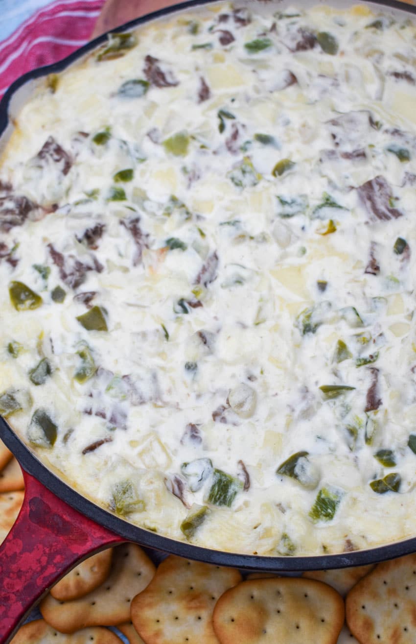 philly cheesesteak dip in a cast iron skillet