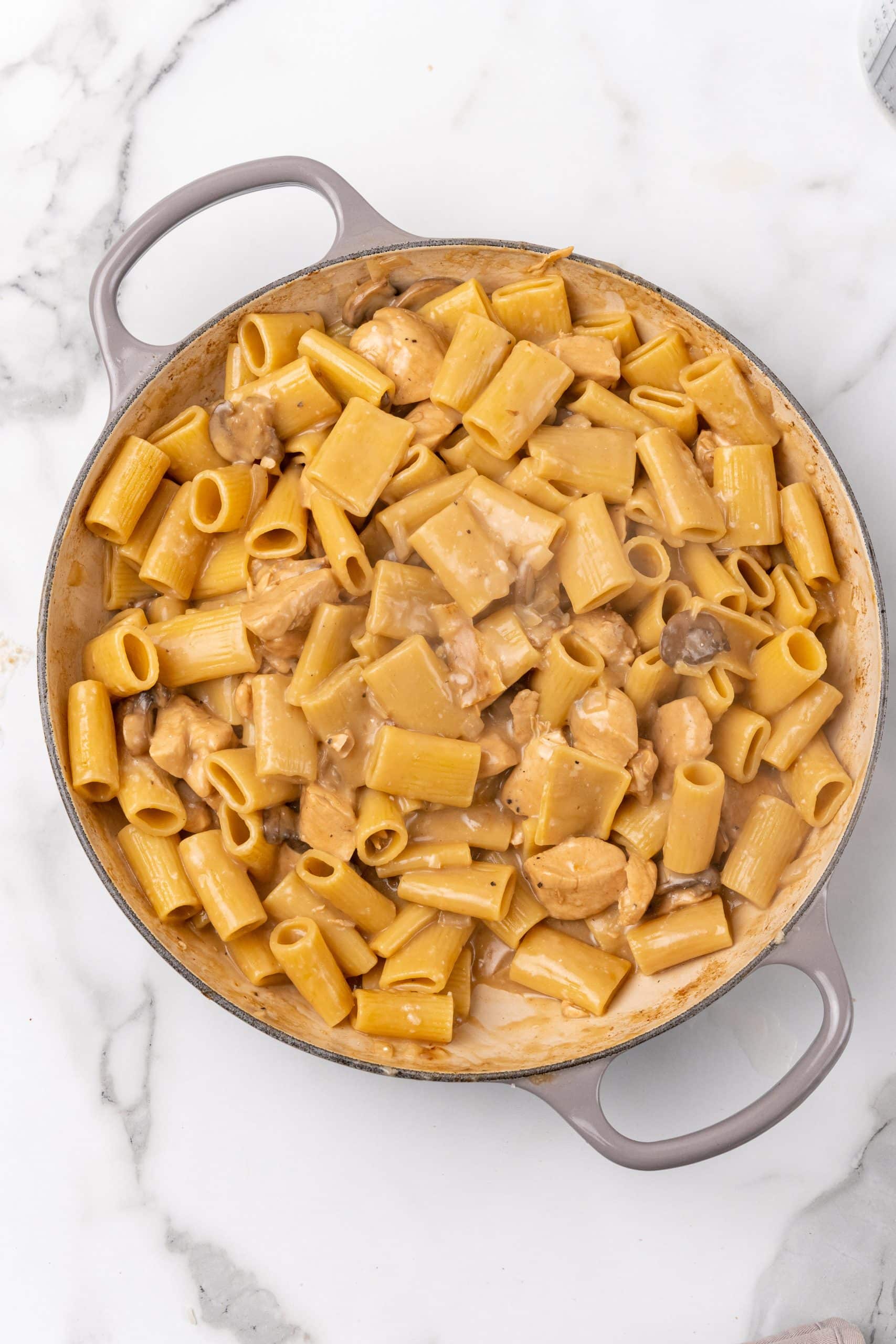 creamy chicken marsala pasta in a gray skillet