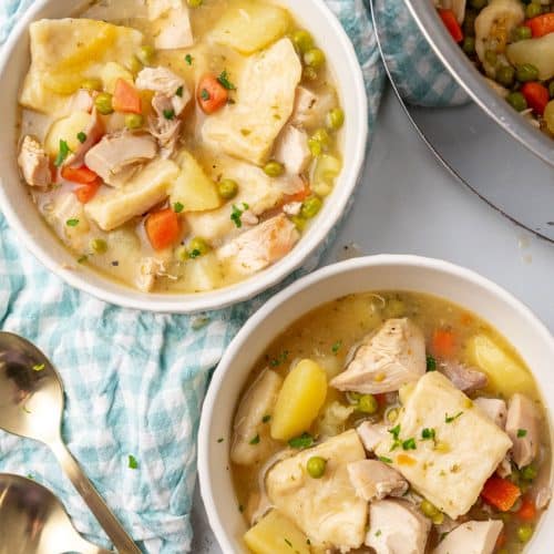 pennsylvania dutch chicken and dumplings in two small white soup bowls
