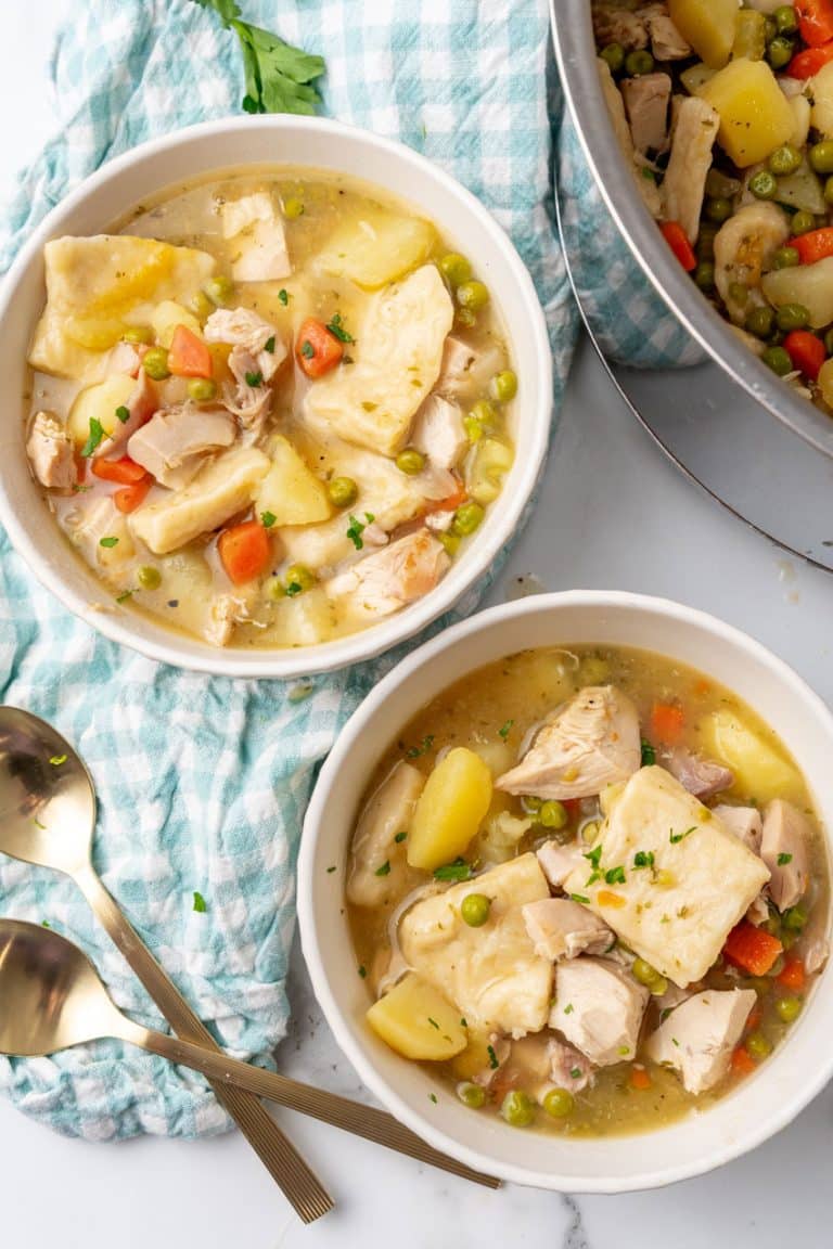 pennsylvania dutch chicken and dumplings in two small white soup bowls