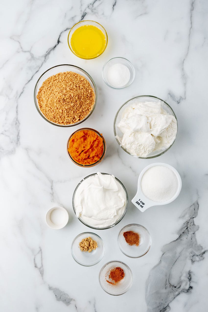 an overhead image showing the measured ingredients needed to make a layered pumpkin ice cream pie dessert