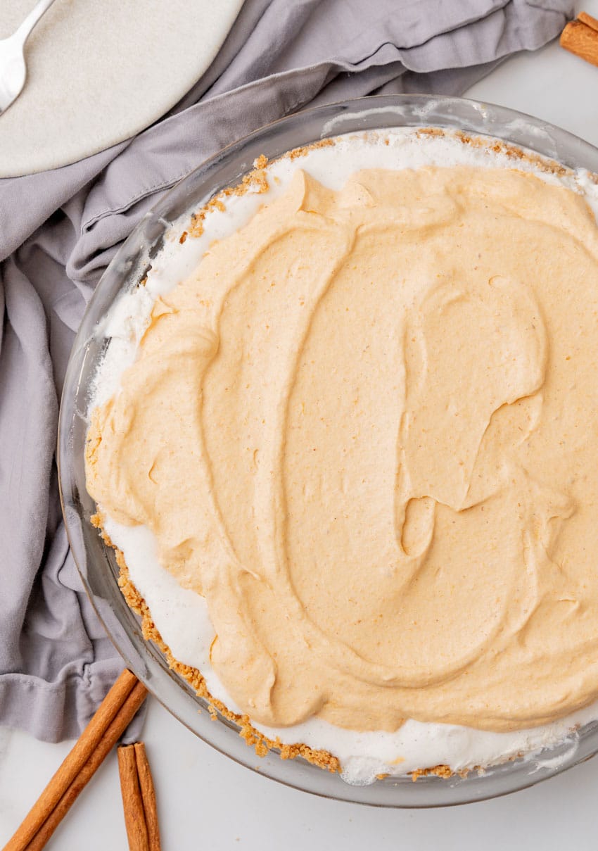 a pumpkin ice cream pie on a white countertop