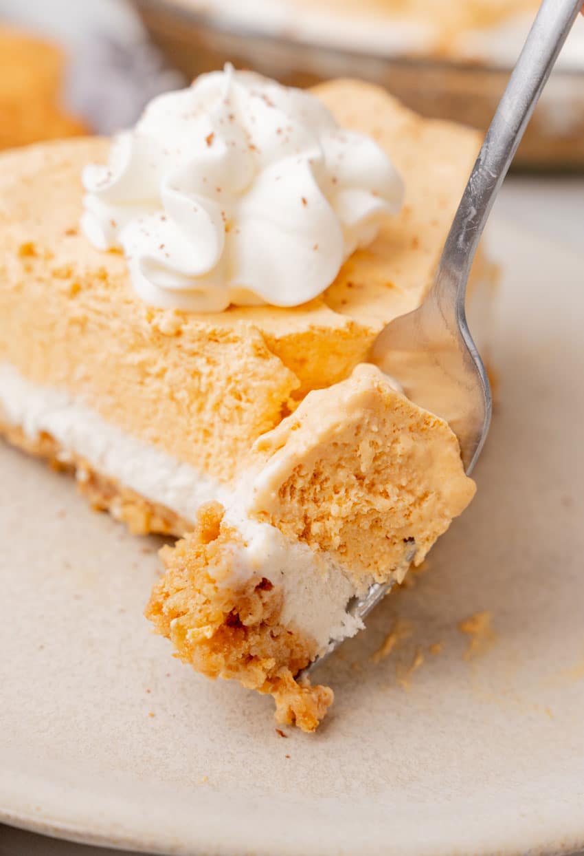 a silver fork lifting up a scoop of pumpkin ice cream pie