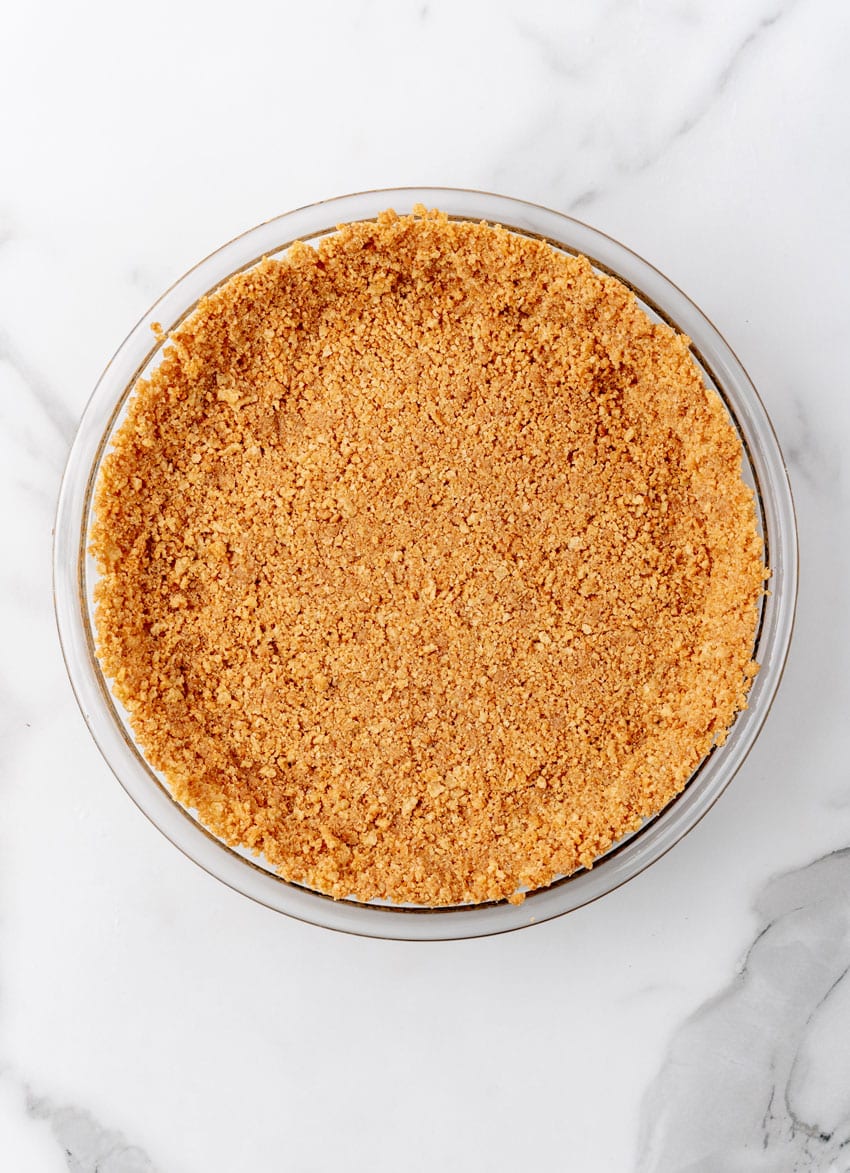 buttered gingersnap cookie crust in a glass pie plate