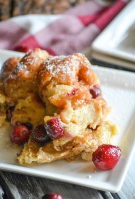 a slice of cranberry donut bread pudding on a small white dessert plate
