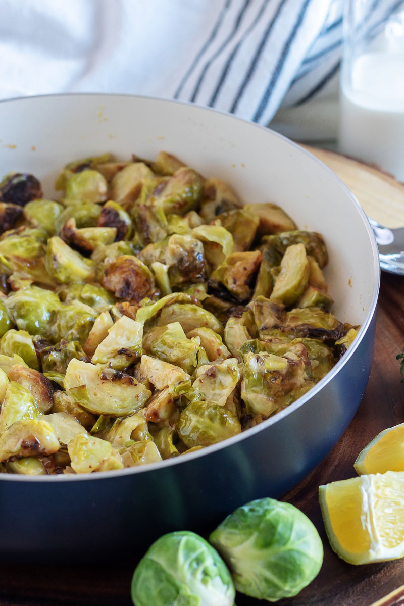 cream braised brussels sprouts in a large blue pot