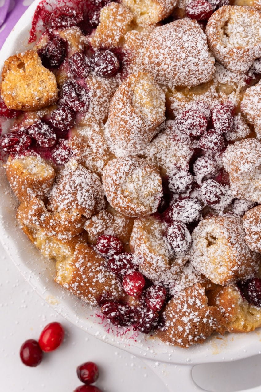 cranberry bread pudding with donuts in a white pie dish