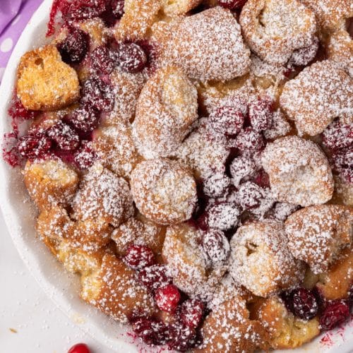 cranberry bread pudding with donuts in a white pie dish