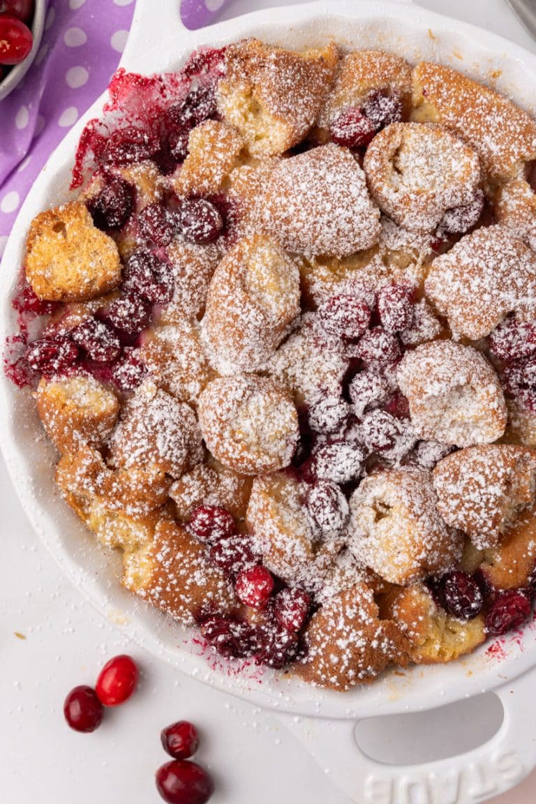 cranberry bread pudding with donuts in a white pie dish