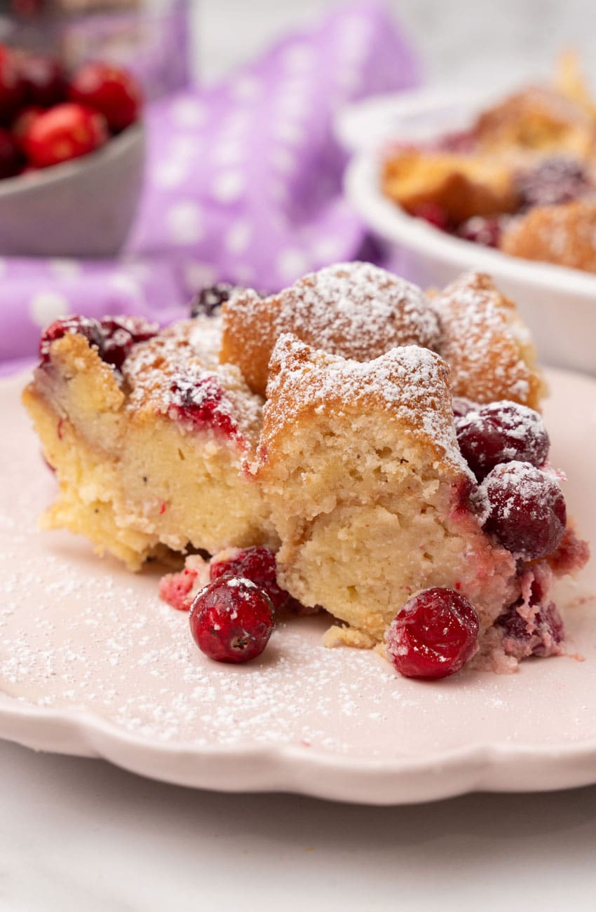 a slice of cranberry bread pudding on a small white dessert plate