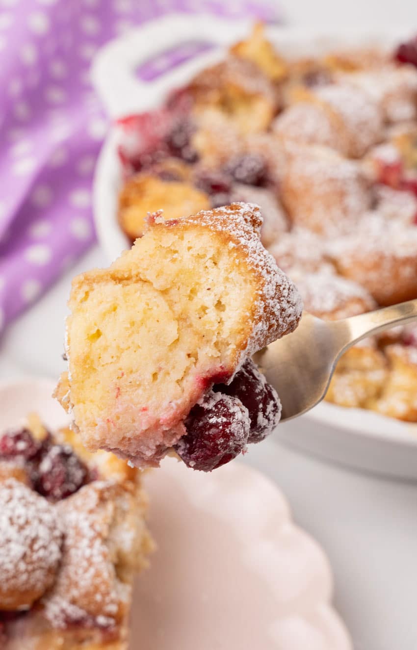 a fork holding up a scoop of cranberry bread pudding