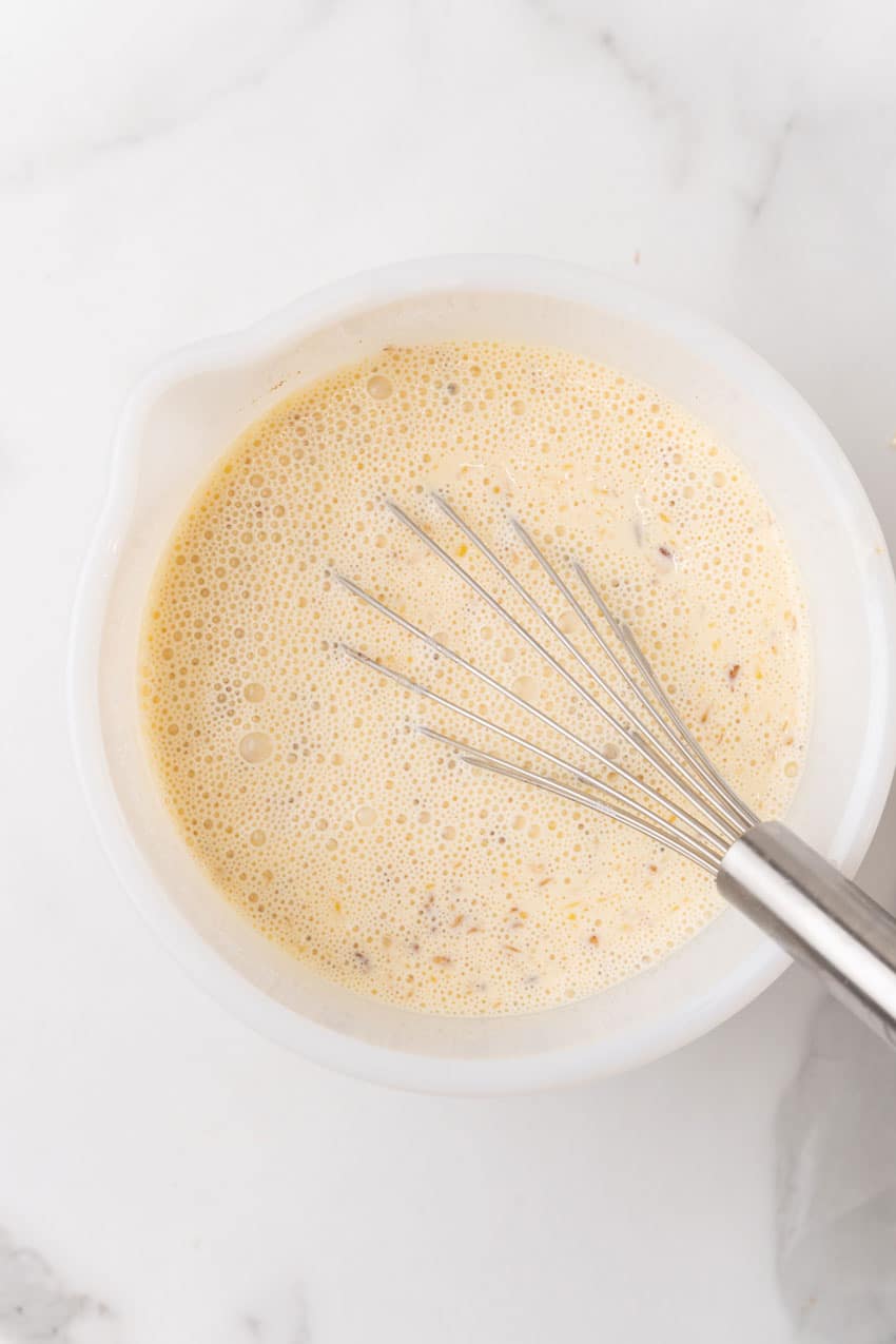 custard mixture in a white mixing bowl