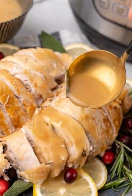 a golden ladle pouring instant pot turkey gravy over sliced turkey breast