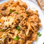 cheesy tomato beef noodle casserole on a white dinner plate