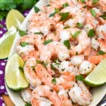 copy cat costco cilantro lime shrimp in a white dish with lime wedges on the side
