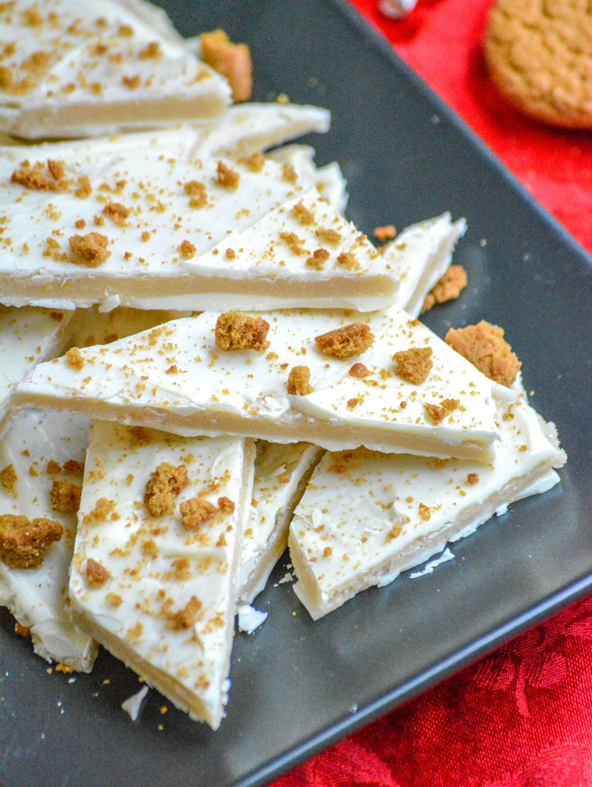 PIECES OF EGGNOG SUGAR COOKIE BARK ON A BLACK SERVING PLATTER