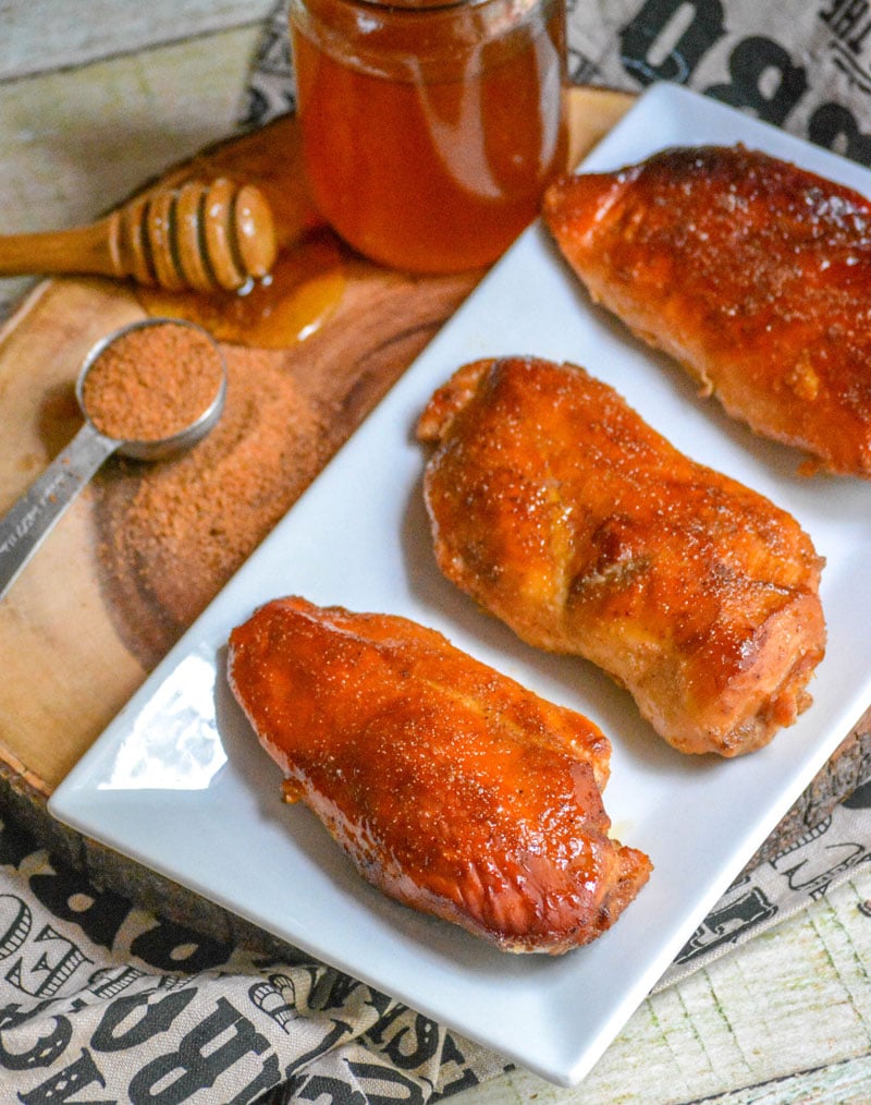 SMOKED CAJUN HONEY CHICKEN BREASTS ON A WHITE SERVING PLATTER