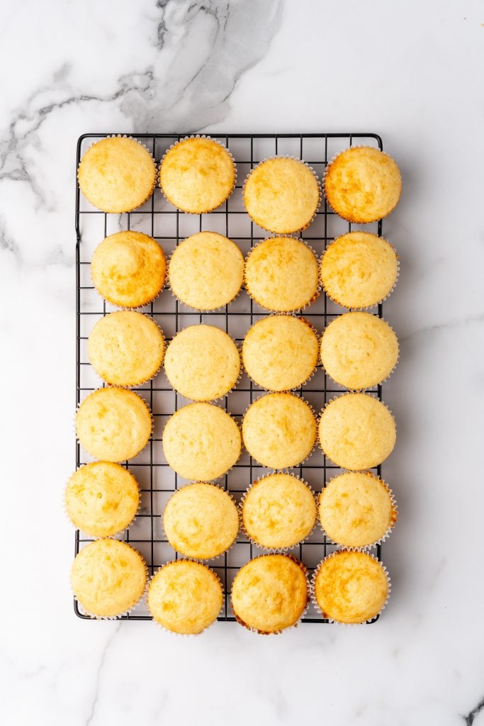 champagne cupcakes on a metal cooling rack