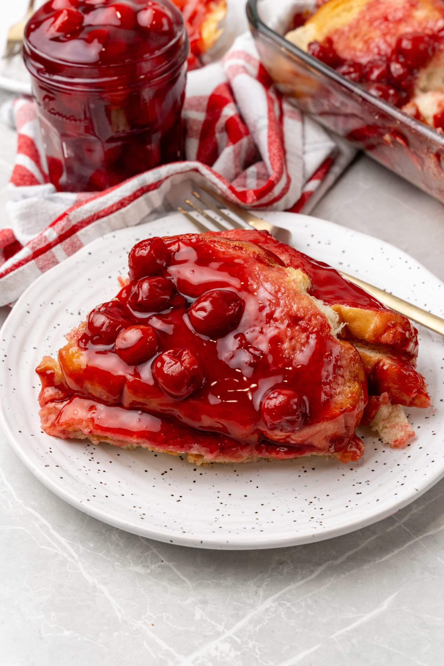 a slice of overnight cherry french toast bake on a white plate