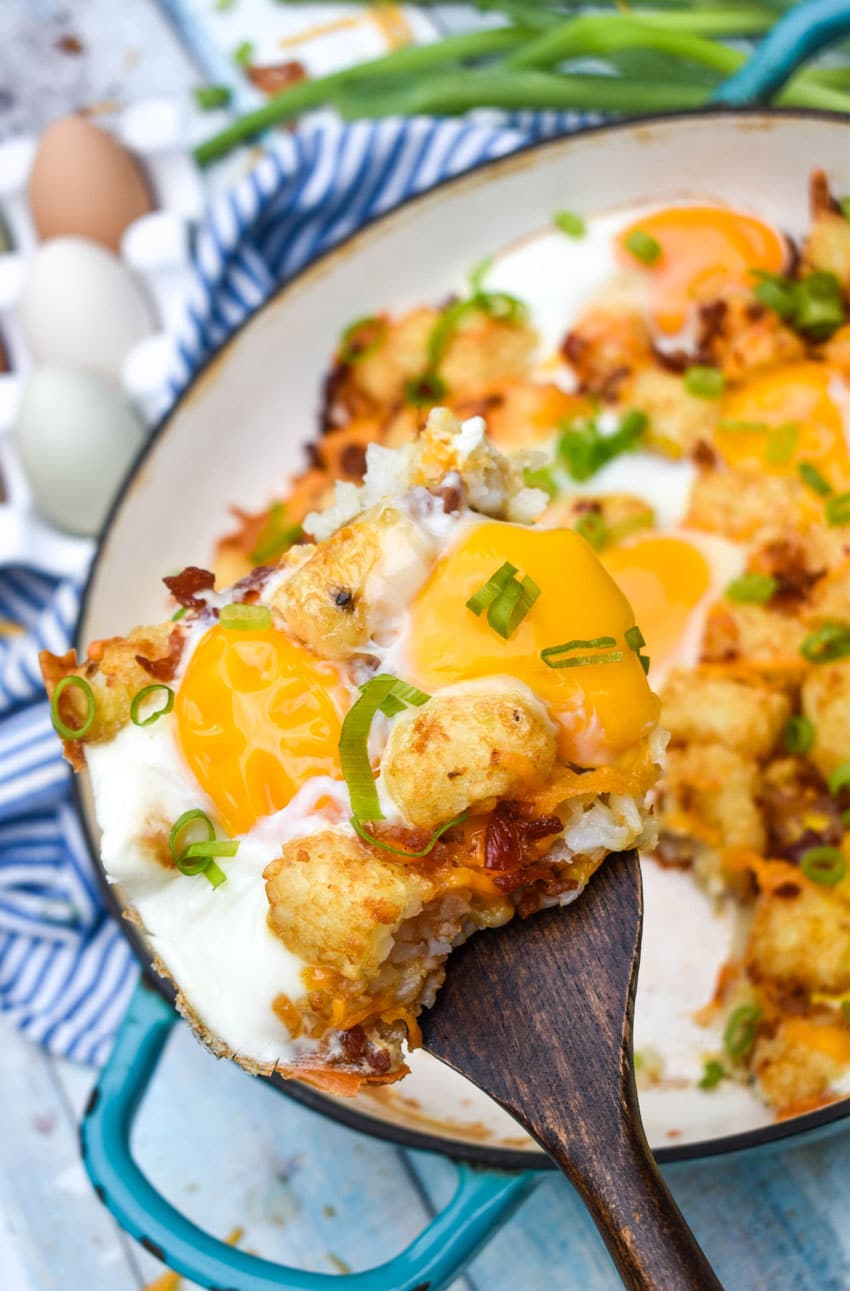 a wooden spatula holding up a slice of breakfast totchos