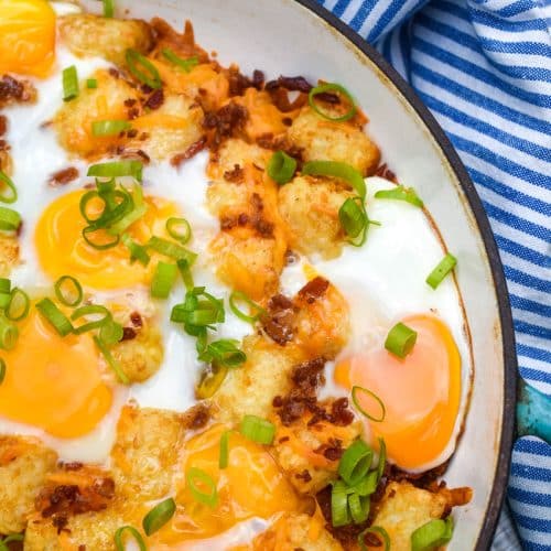 breakfast totchos in a blue cast iron skillet