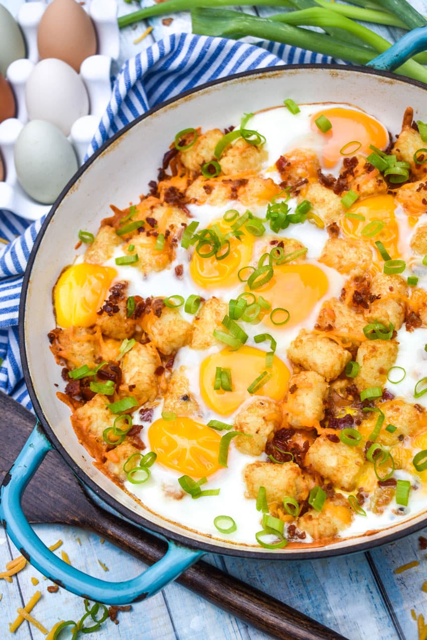 breakfast totchos in a blue cast iron skillet