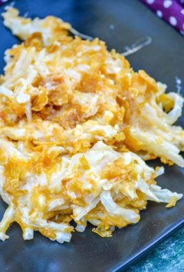 CHEESY HASH BROWN CASSEROLE ON A BLACK PLATE