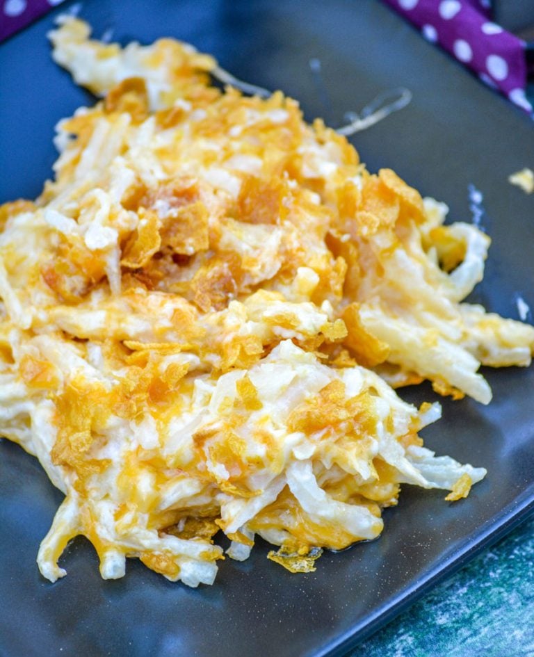 CHEESY HASH BROWN CASSEROLE ON A BLACK PLATE