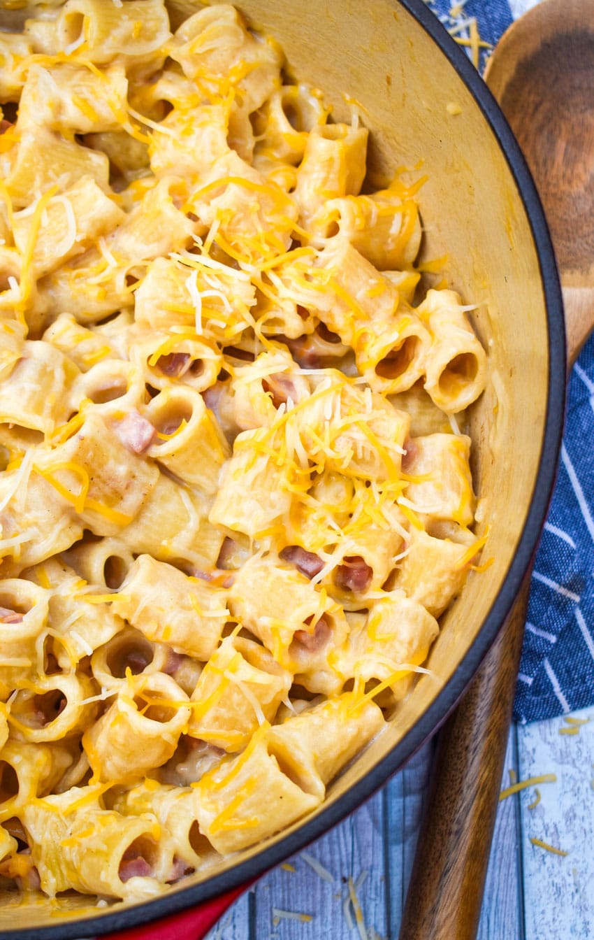 cheesy riggies pasta with ham in a large red dutch oven