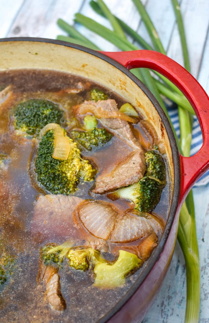 chinese beef and broccoli soup in a large red dutch oven