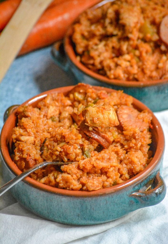 Dutch Oven Jambalaya with chicken and smoked sausage served in blue glazed terra cotta bowls