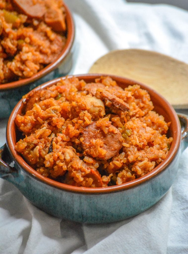 Dutch Oven Jambalaya with chicken and smoked sausage served in blue glazed terra cotta bowls