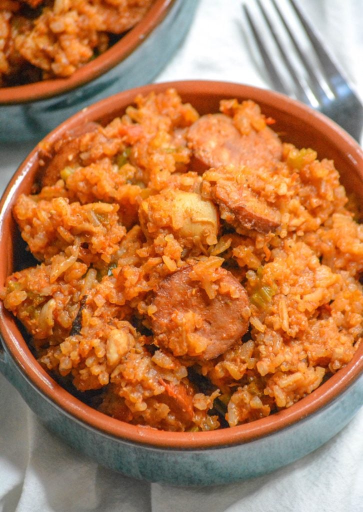 Dutch Oven Jambalaya with chicken and smoked sausage served in blue glazed terra cotta bowls