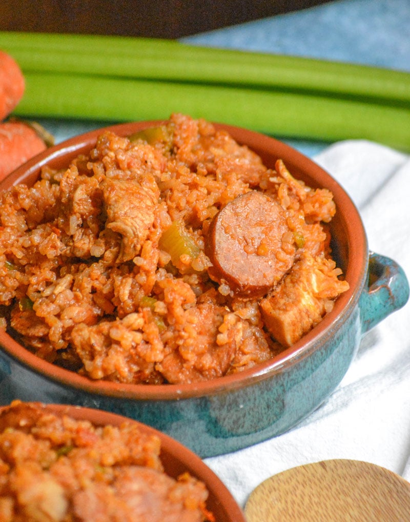 Dutch Oven Jambalaya with chicken and smoked sausage served in blue glazed terra cotta bowls