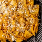 cheesy chicken chilaquiles in a gray skillet
