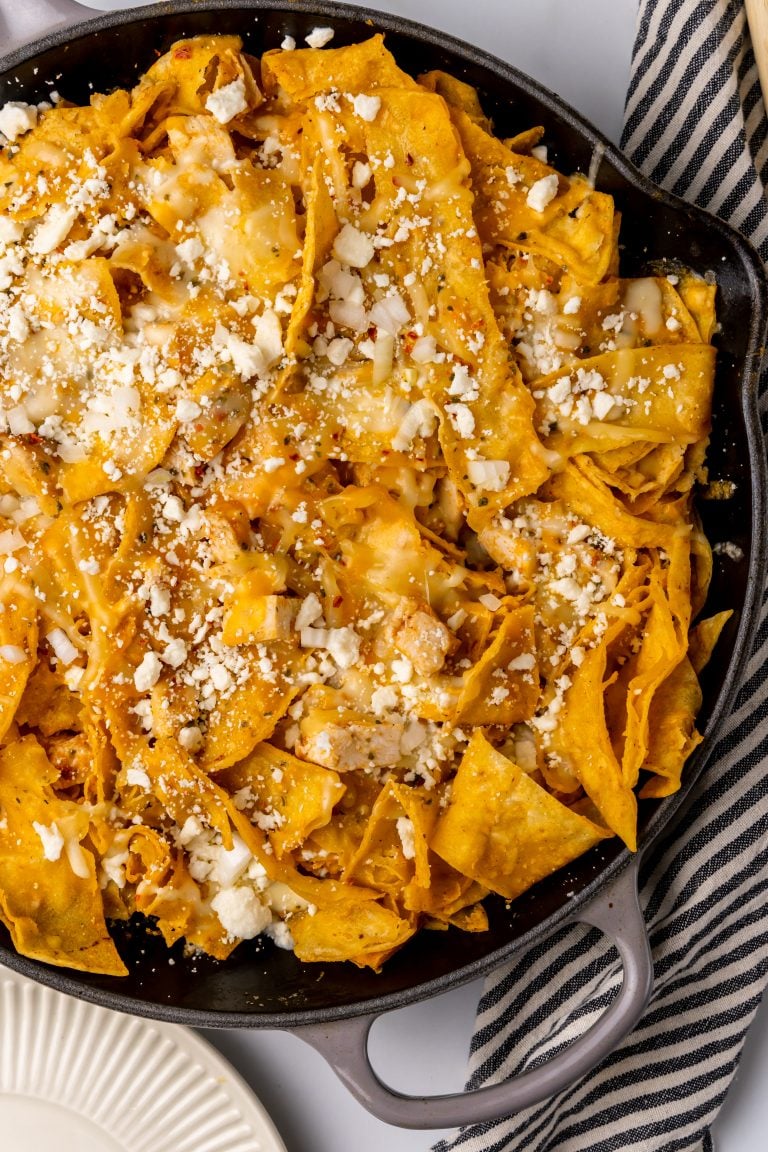 cheesy chicken chilaquiles in a gray skillet