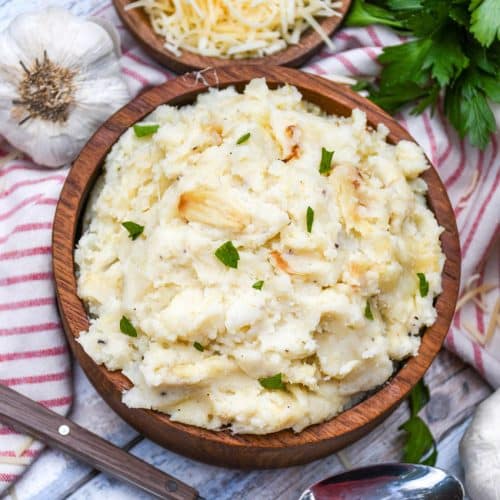creamy roasted garlic mashed potatoes in a wooden bowl