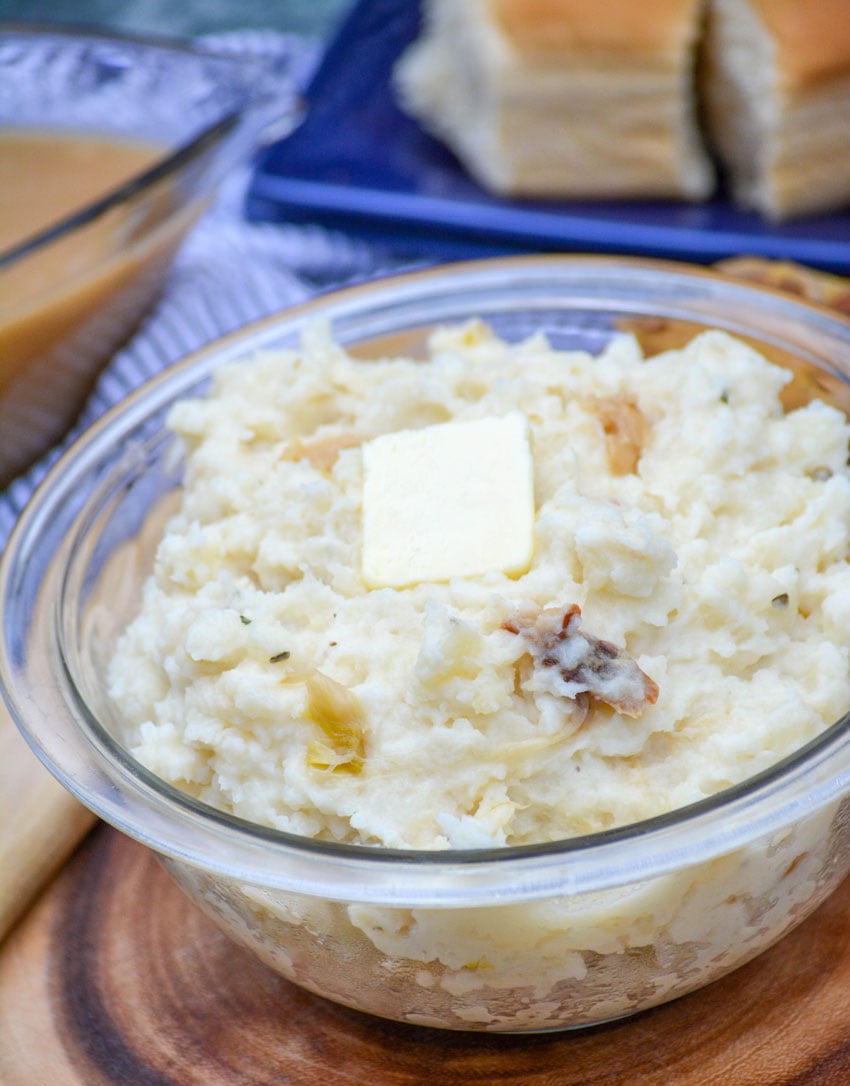 CREAMY ROASTED GARLIC MASHED POTATOES IN A GLASS MIXING BOWL