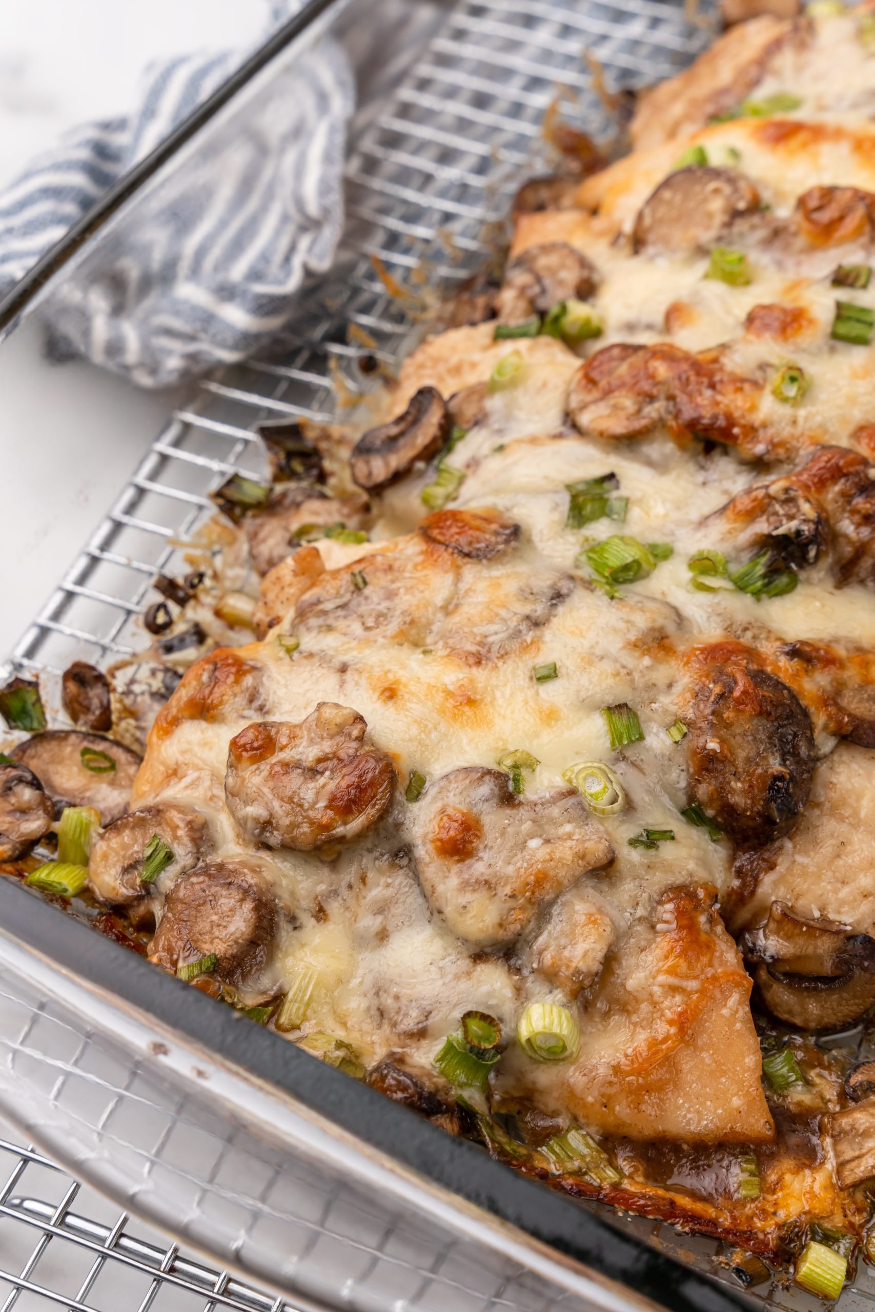 pieces of chicken lombardy in a glass baking dish