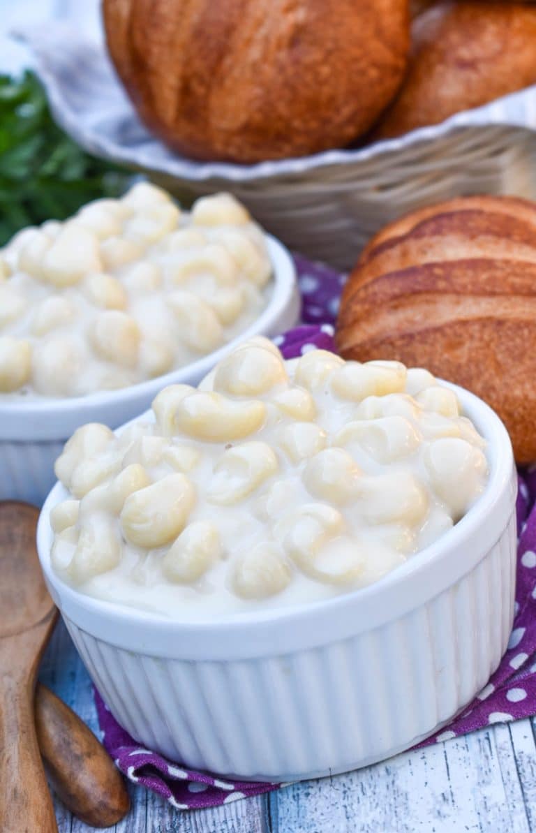 copycat panera mac and cheese recipe shown in two white ramekins with crusty rolls on the side