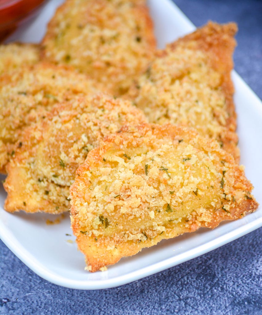 OVEN BAKED TOASTED RAVIOLI ON A WHITE SERVING PLATTER