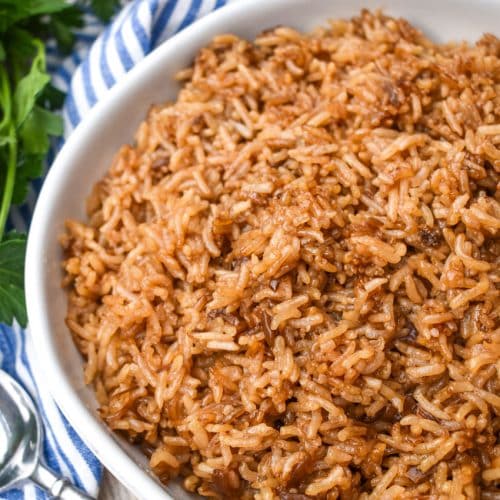 stick of butter rice in a large white serving bowl